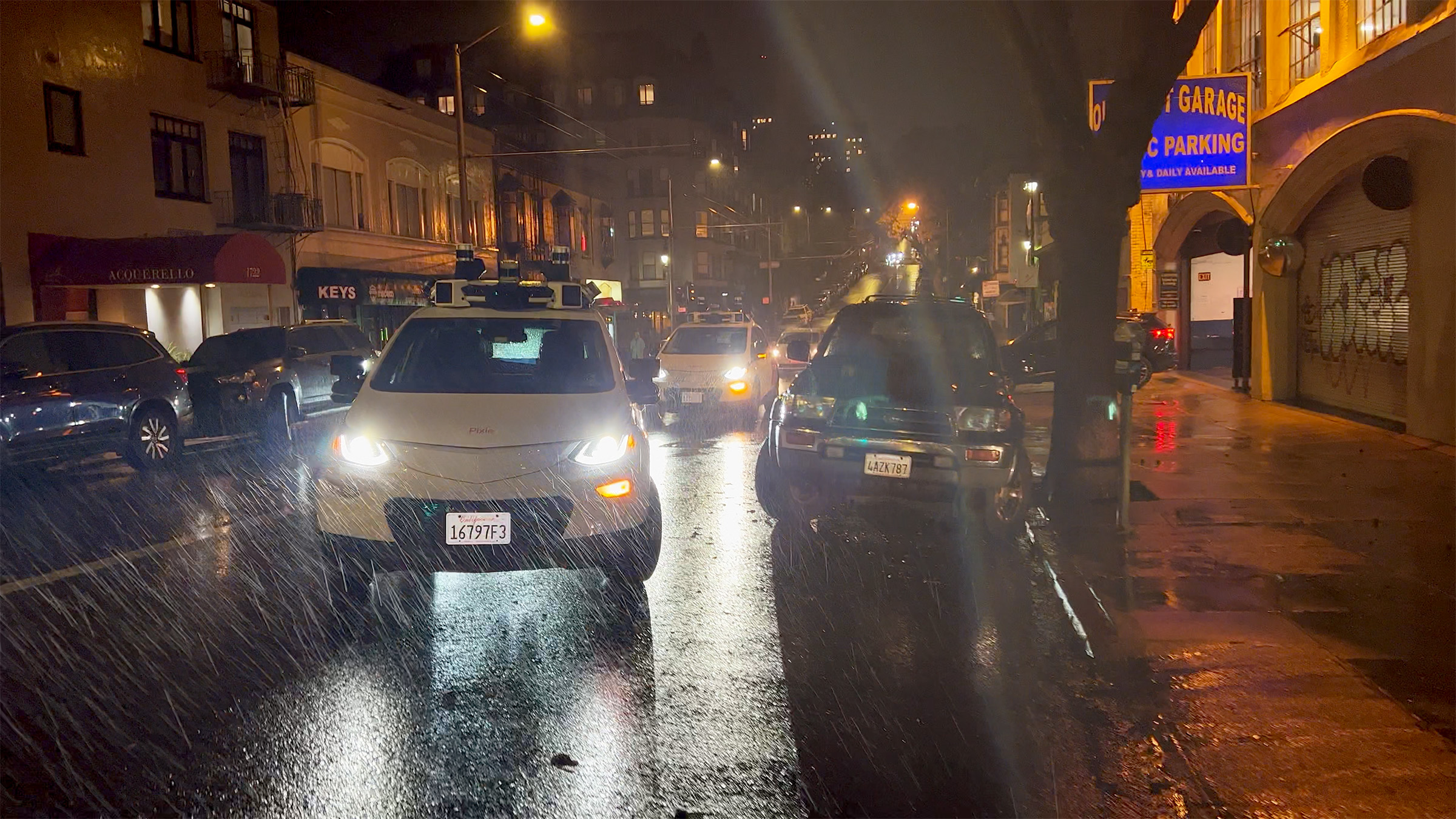 Two vehicles turn into a driveway