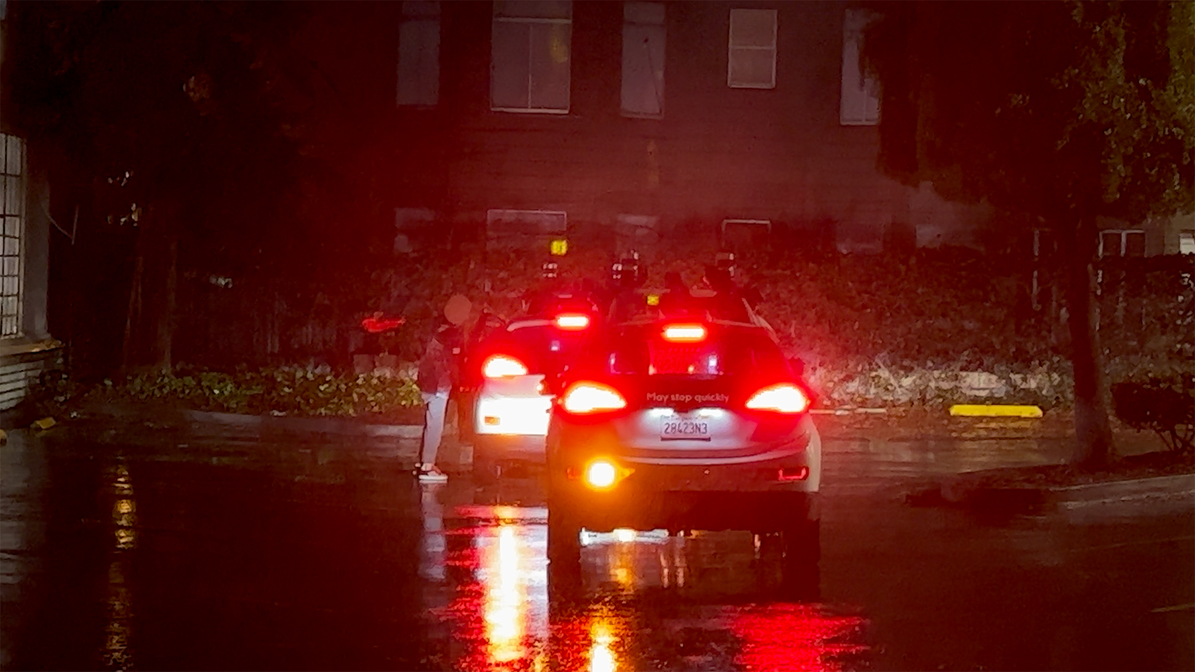 A person enters the driver's door of a vehicle